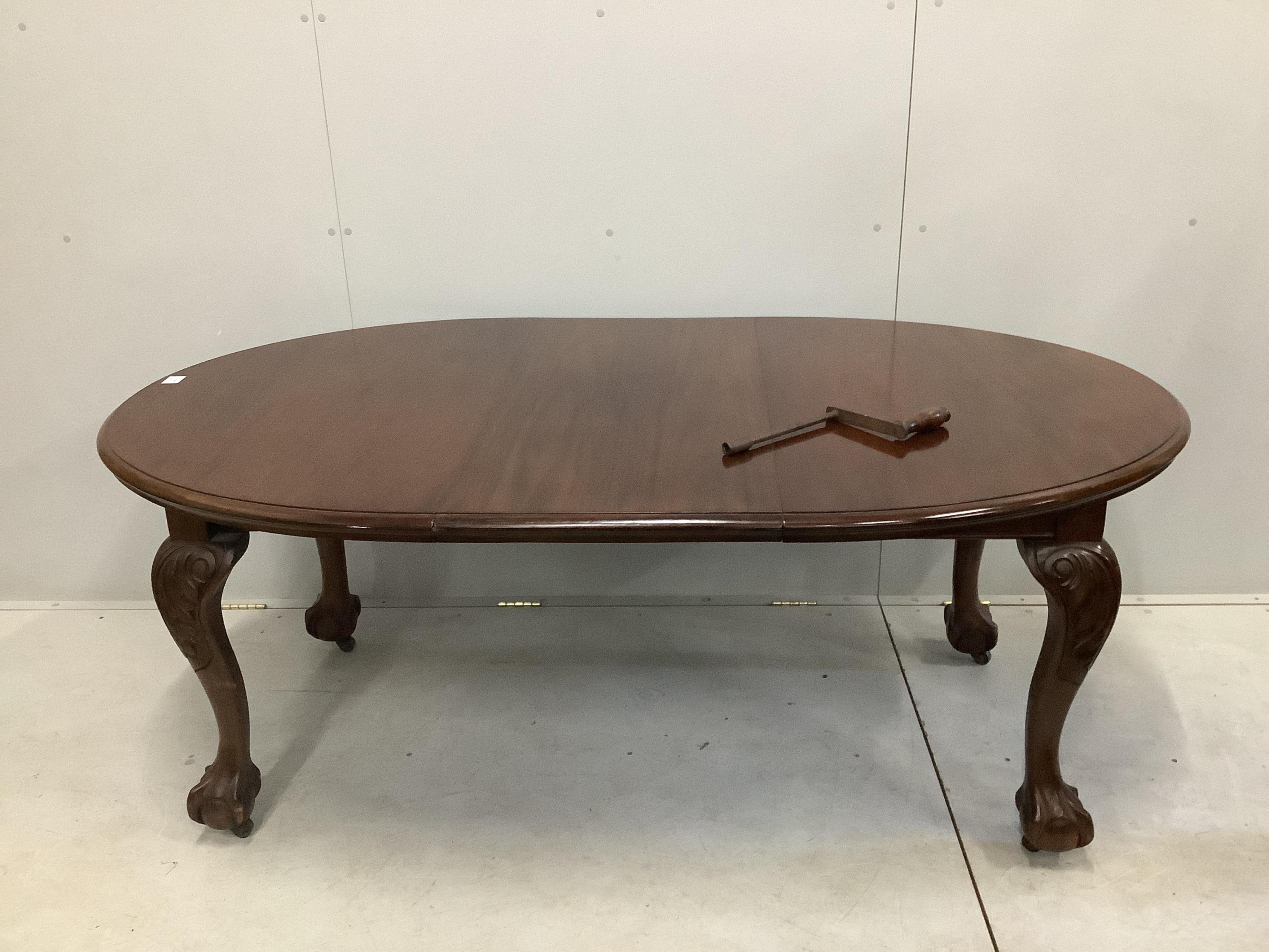 A 1930's walnut extending dining table, 182cm extended, height 106cm and a set of six Queen Anne Revival dining chairs. Condition - fair to good